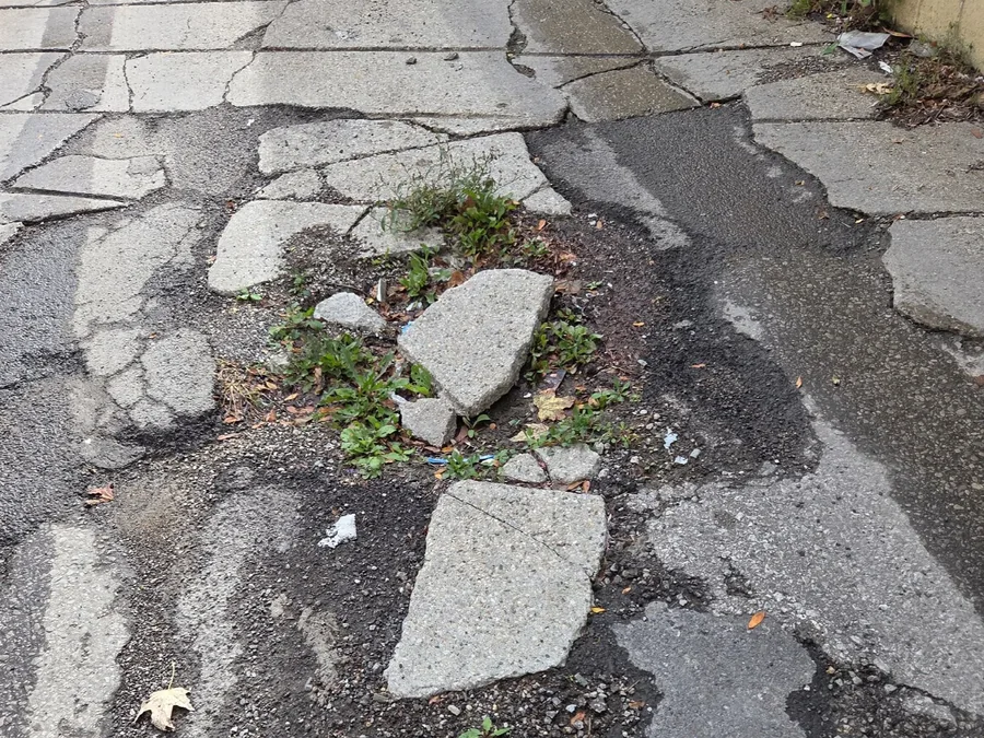 Broken, heaved pavement on a driveway ramp