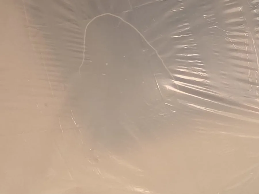 Plastic sheeting holding up a damaged ceiling