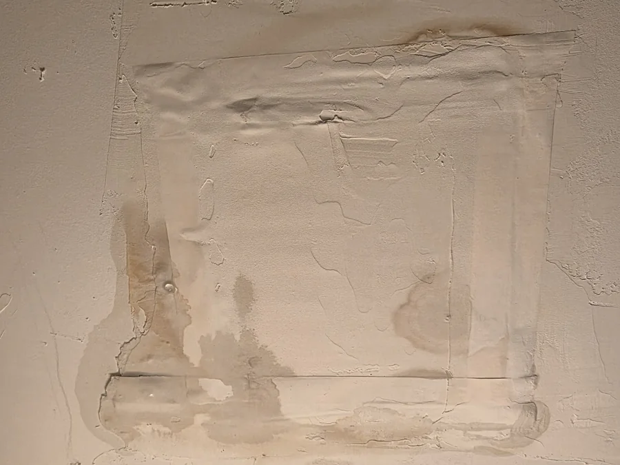 Water-stained, bubbling ceiling plaster